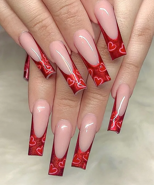Red glitter hearts: Deep French in red glitter with painted hearts, done at Enchanted